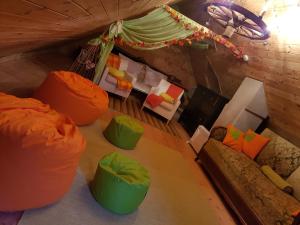 ein Wohnzimmer mit orangefarbenen und grünen Stühlen in der Unterkunft Kis Sziget Vendégház in Nagybörzsöny