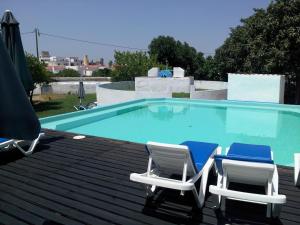 a pair of chairs and a swimming pool at Hotel de Moura in Moura