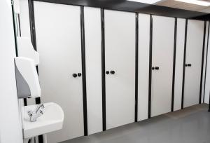 a bathroom with white lockers and a sink at Nivå Camping & Cottages in Nivå