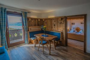 a living room with a table and a bedroom at Apartment Christine in Weyregg