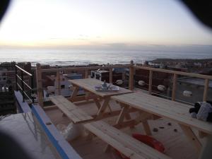 a picnic table on the roof of a building at Seaside House in Imsouane