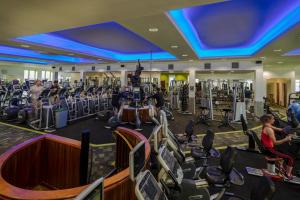 a gym with a lot of treadmills and machines at Citywest Hotel in Citywest