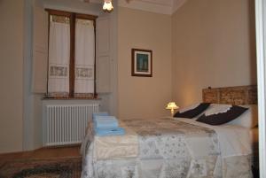 a bedroom with a bed and a lamp and a window at Casa Dolce Casa in Pienza