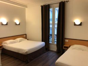 a hotel room with two beds and a window at Hôtel Liège Strasbourg in Paris