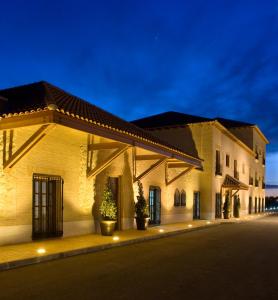 a building on a street at night at Bodegas Hacienda Albae in Argamasilla de Alba