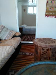 uma sala de estar com um sofá e uma mesa em Odyssey Guest House em Bergama