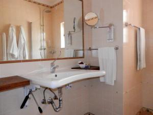 a white bathroom with a sink and a mirror at Solar de Mos in Lagos