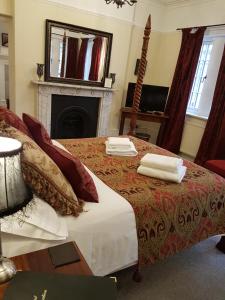 a bedroom with a bed with two towels on it at Gothic House in East Grinstead