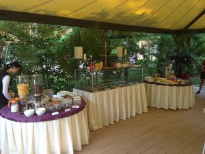 a buffet of food on tables under a tent at Hotel Sara in Neptun