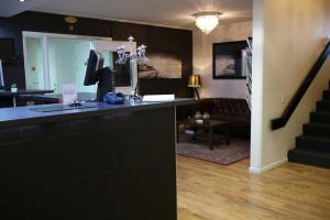 a living room with a black counter and a staircase at Hotell Marieberg in Kristinehamn
