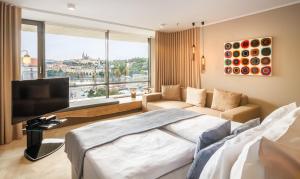 a hotel room with a bed and a large window at The President in Prague