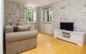 a living room with a couch and a flat screen tv at M.A.S. in Supetar