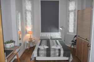 a bedroom with a bed and a table with a lamp at Megaron11 Apartments in Thessaloniki