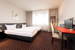 Säng eller sängar i ett rum på ACHAT Hotel Hockenheim