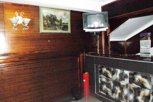 a living room with a fireplace and a tv at Palm world Hotels Mbarara in Mbarara