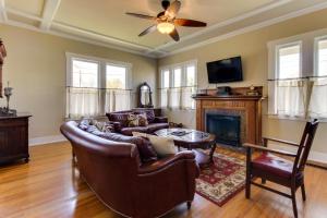 a living room with leather furniture and a fireplace at Travis Street in Fredericksburg