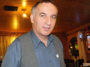 a man is standing in a room at Fehérló Vendégház & Restaurant in Bük