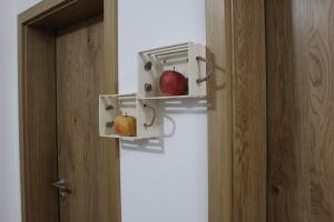 an oven with two apples in it next to a door at Vdovič Guest House in Svečina