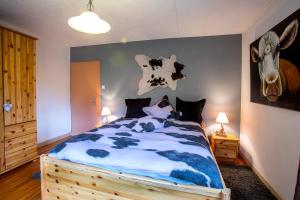 a bedroom with a bed with a deer head on the wall at Gite Chez Mimie in Breitenbach-Haut-Rhin