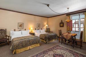 Posteľ alebo postele v izbe v ubytovaní Hotel Dann Monasterio