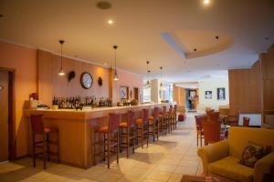 a bar in a restaurant with a lot of chairs at Neda Hotel in Olympia