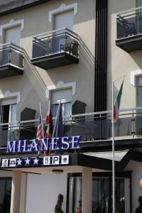 a sign for the meeniss inn in front of a building at Hotel Milanese in Rimini