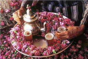 a person holding a plate with a tea pot and drinks at Thalassa in Oualidia