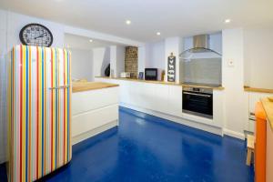 a kitchen with blue floors and a refrigerator at Central Regency Town House in Brighton & Hove