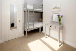 a bedroom with bunk beds and a desk and a mirror at Central Regency Town House in Brighton & Hove +29 photos