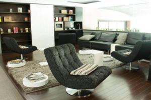 ein Wohnzimmer mit Sofa und Stühlen in der Unterkunft Studio Loft Polanco with POOL in Mexiko-Stadt