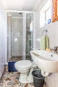 a bathroom with a toilet and a sink at Walkerview Apartments in Gansbaai