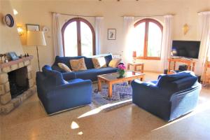 sala de estar con sofás azules y chimenea en MARYVILLA 57, en Calpe
