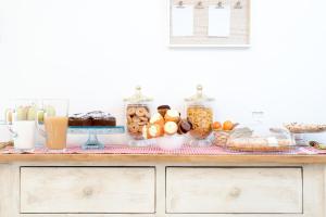 a table filled with different types of food and drinks at La Viola e il Sole - alloggi e glamping - in Fermo