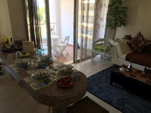 a living room with a table and a couch at Ocean View BGB Resort in Bouznika