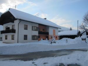 a building covered in snow with a lot of snow at Gästehaus Holzfeind in Hermagor