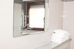 a mirror in a bathroom with towels on a counter at Villa Raljević in Stanići +36 photos