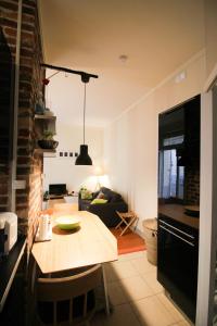 a kitchen and living room with a table and a couch at Apartment Boulevard Brune in Paris