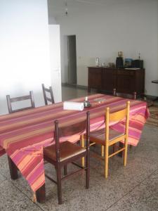 a large wooden table with two chairs and a tableablish at Farida Lodge in Moroni