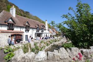 a group of people standing in front of a building at Lulworth Lodge in Lulworth Cove