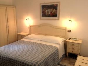 Postel nebo postele na pokoji v ubytování Hotel Umbria