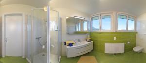 a bathroom with a shower and a sink at Karglhof Villa in Faak am See +73 photos