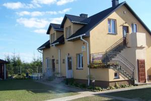 a large house with stairs and a balcony at Baltic-House in Gąski