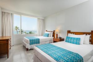 Postel nebo postele na pokoji v ubytování Hotel Dann Cartagena
