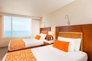 Postel nebo postele na pokoji v ubytování Hotel Dann Cartagena