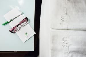 a pair of glasses sitting on top of a white shirt at Holiday Inn Downtown Rochester, an IHG Hotel in Rochester