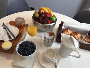 a table with a tray of food and a bowl of fruit at Carlton Hotel in Ilfracombe