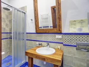a bathroom with a sink and a mirror and a shower at Shpatser hotel in Briukhovychi +19 photos