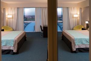 Una cama o camas en una habitación de Gala Hotel y Convenciones