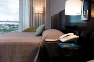 Una cama o camas en una habitación de Gala Hotel y Convenciones
