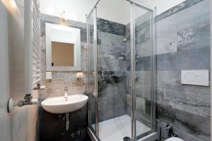 a bathroom with a sink and a shower at Midnight in Rome Guest House in Rome